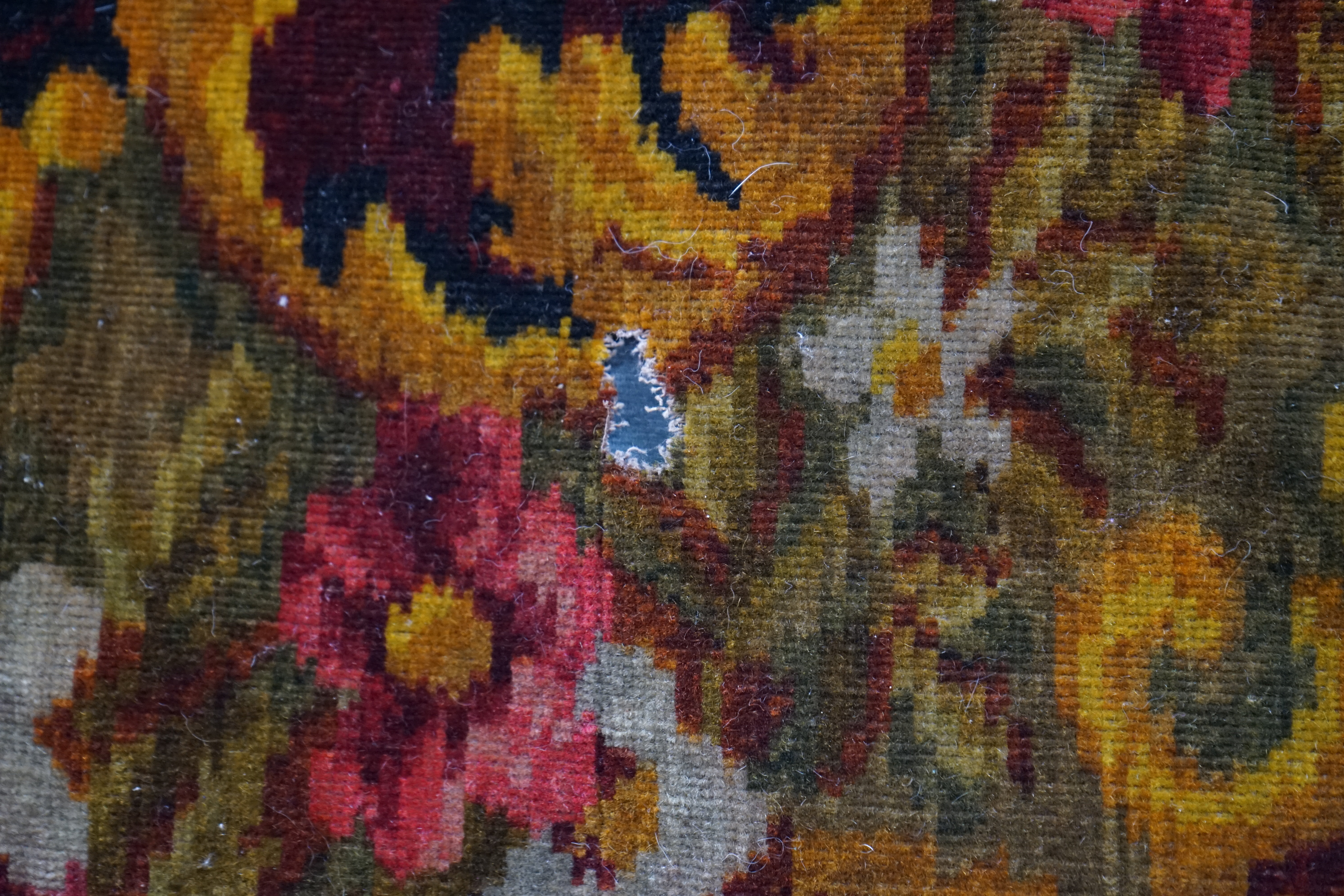 An Edwardian table cover in brightly coloured wools, with a floral design, together with a later 20th century continental grey, beige and cream patterned silk cover, Edwardian table cover 220cm x 172cm. Condition - colou